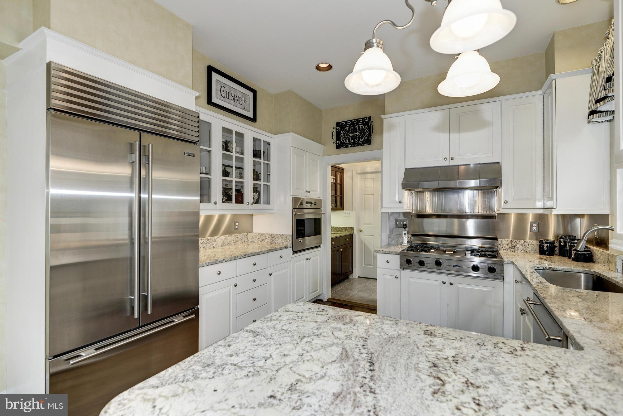 1616 S Street Northwest Washington, DC 20009 - Photo 13 of 30 a kitchen with stainless steel appliances granite countertop a refrigerator a stove and a sink