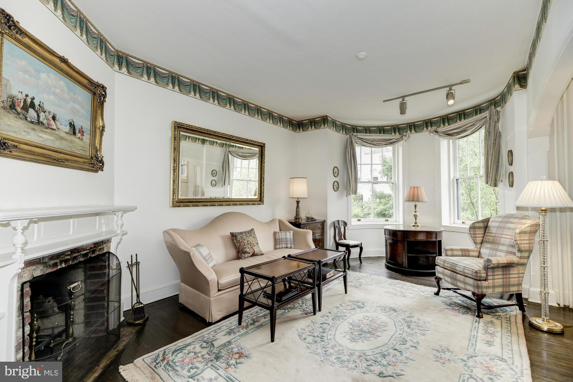 1616 S Street Northwest Washington, DC 20009 - Photo 19 of 30 a living room with furniture a fireplace and a large window