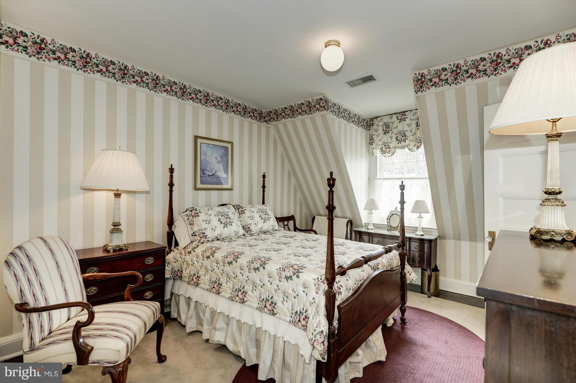 1616 S Street Northwest Washington, DC 20009 - Photo 23 of 30 a bedroom with a bed a mirror and a window