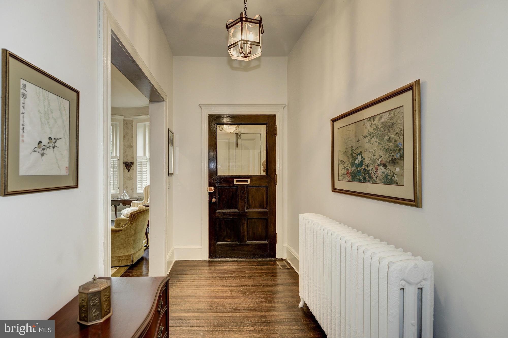 1616 S Street Northwest Washington, DC 20009 - Photo 4 of 30 a view of a hallway with furniture and wooden floor