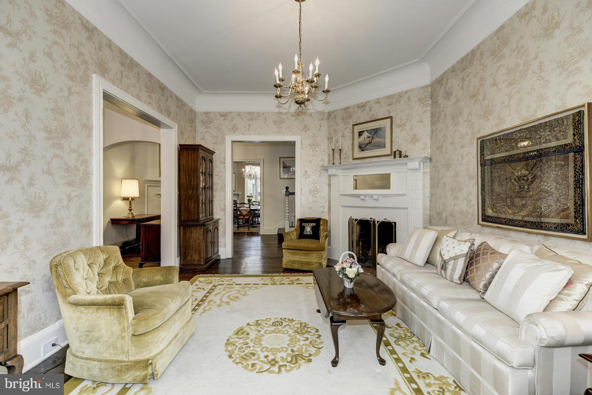 1616 S Street Northwest Washington, DC 20009 - Photo 7 of 30 a living room with furniture a fireplace and a chandelier