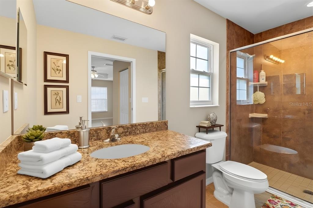 1 Pecan Course Circle Ocala, FL 34472 - Photo 9 of 24 a bathroom with a granite countertop sink mirror toilet and shower