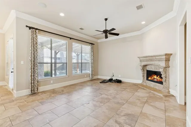 a view of an empty room with a fireplace and a window