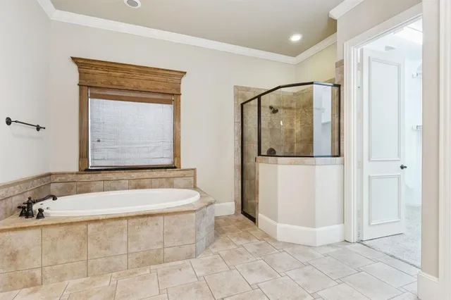 a spacious bathroom with a tub sink and mirror