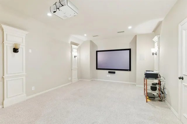 an empty room with projector and screen