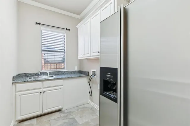 a kitchen with granite countertop cabinets and window