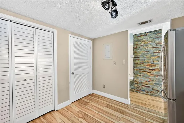 a view of a livingroom with wooden floor and a window