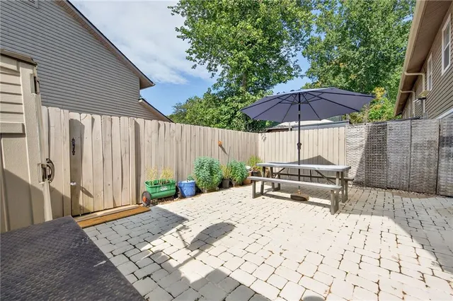 a view of a backyard with chairs and a small yard