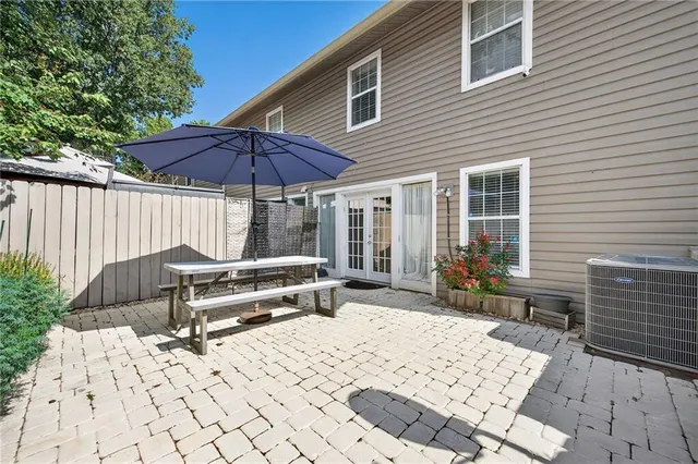a backyard of a house with barbeque oven table and chairs