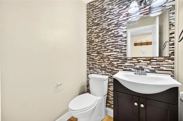 a bathroom with a sink a toilet and mirror