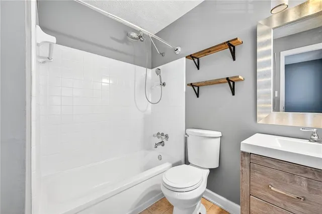 a bathroom with a toilet sink and shower
