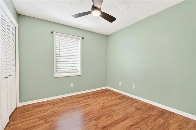 a view of a room with wooden floor and windows