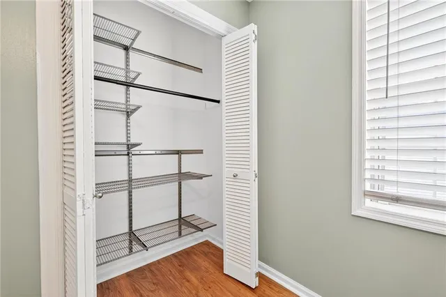 a view of a room with racks on the wall and a window