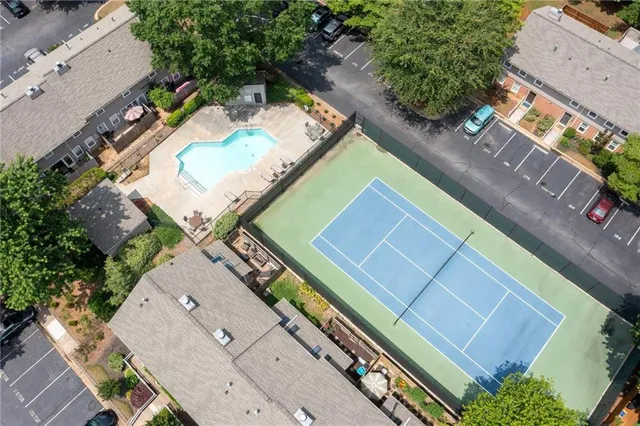 an aerial view of a tennis ground and a yard