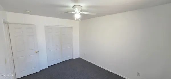 an empty room with windows and closet