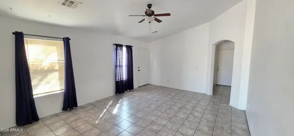 a view of a room with a ceiling fan and a window