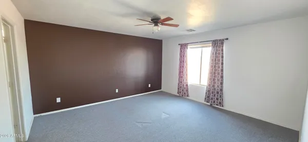 an empty room and a ceiling fan in closet