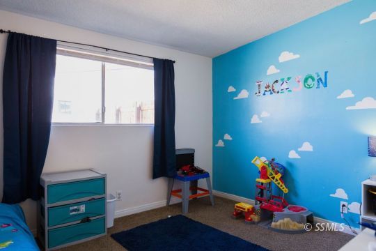 308 West Howell Avenue Ridgecrest, CA 93555 - Photo 22 of 32 a living room with furniture and a window