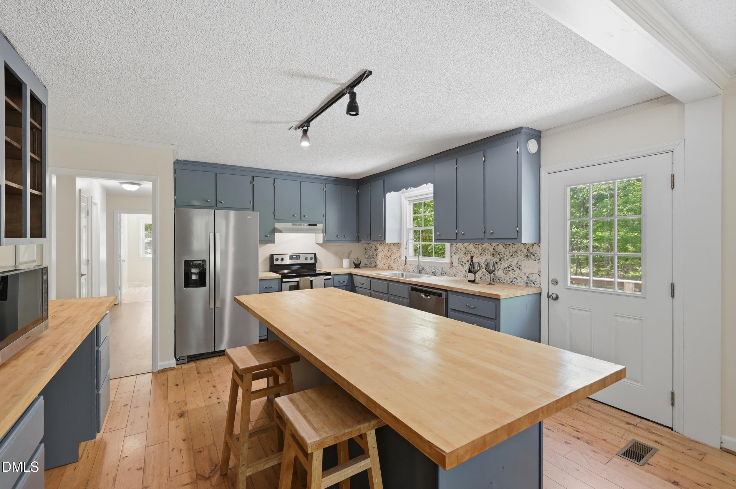 7811 Buckhorn Road Hillsborough, NC 27278 - Photo 13 of 47 a large kitchen with a table and chairs