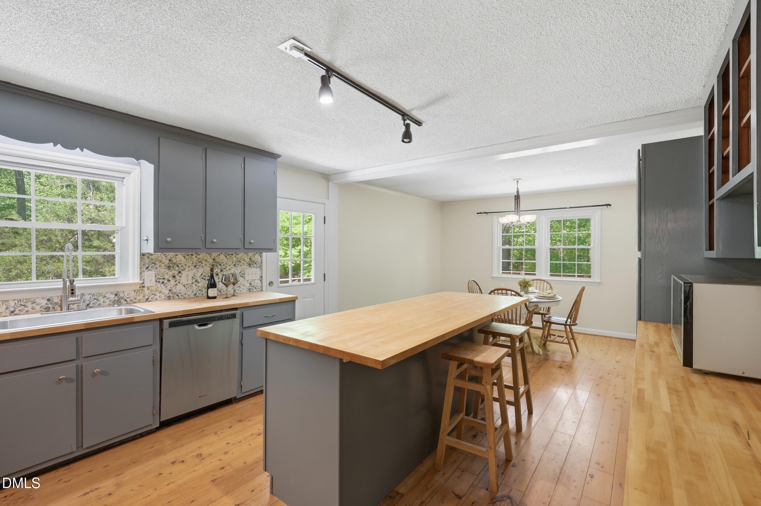 7811 Buckhorn Road Hillsborough, NC 27278 - Photo 14 of 47 a open kitchen with a sink and wooden cabinets