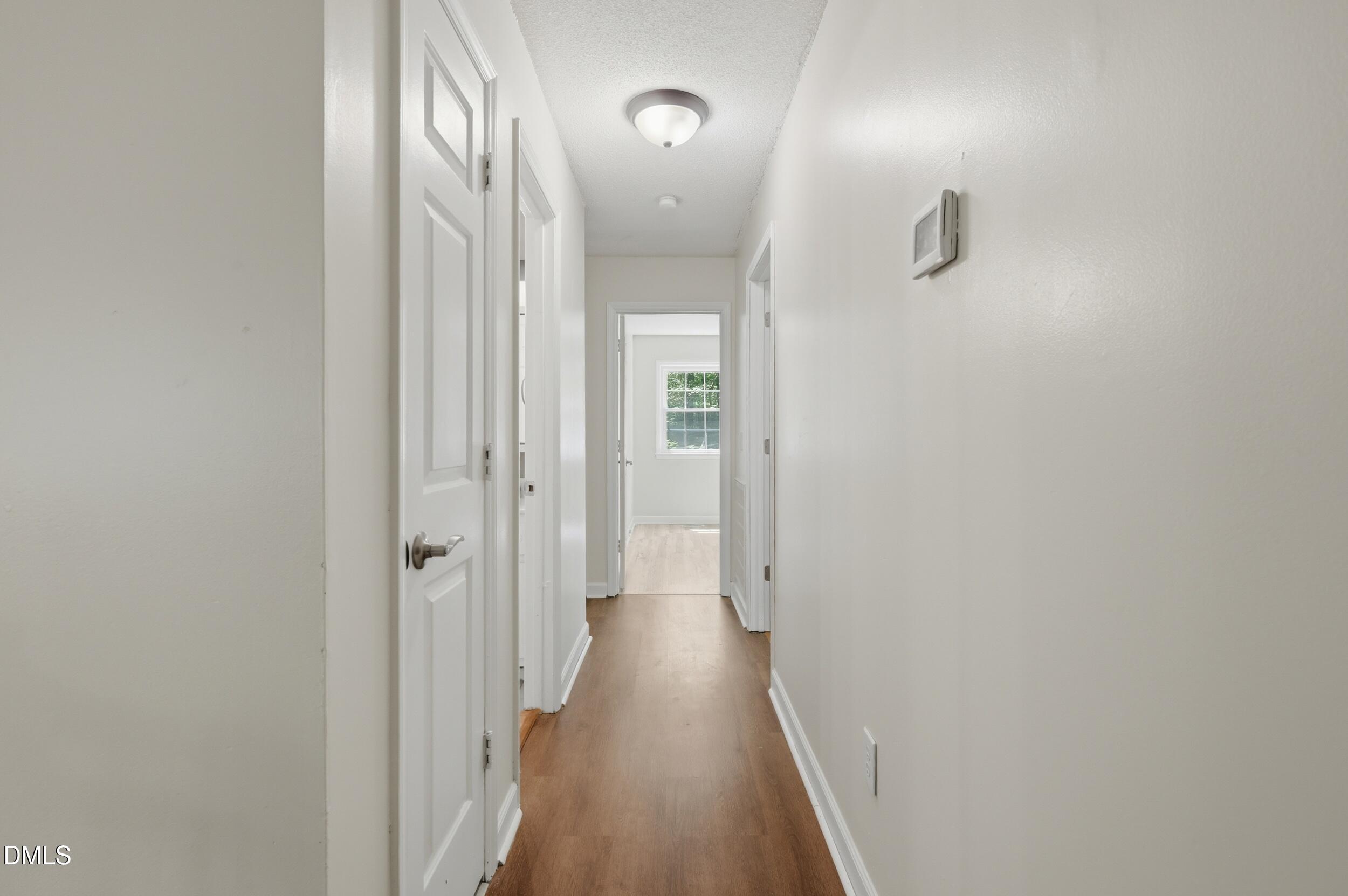 7811 Buckhorn Road Hillsborough, NC 27278 - Photo 15 of 47 a view of a hallway with wooden floor
