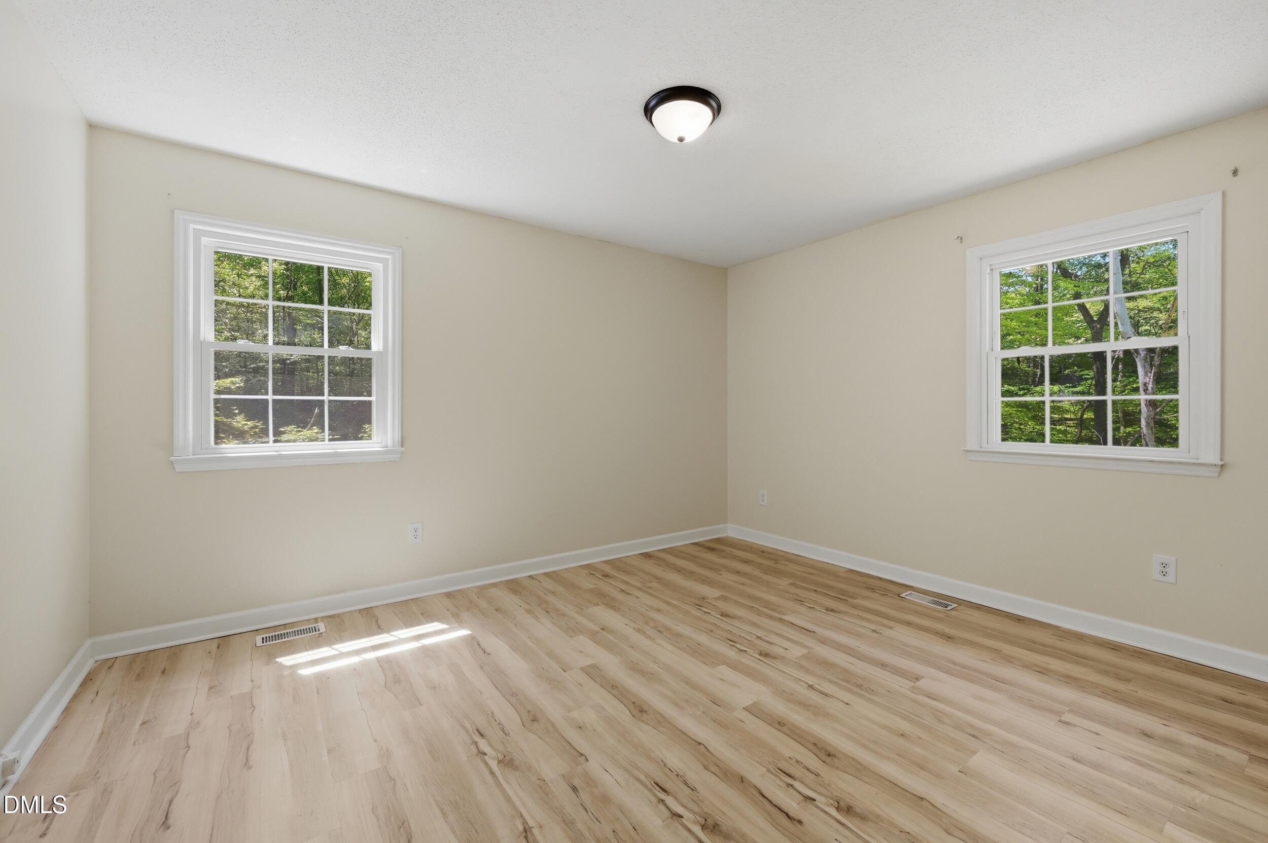 7811 Buckhorn Road Hillsborough, NC 27278 - Photo 19 of 47 a view of empty room with wooden floor and fan