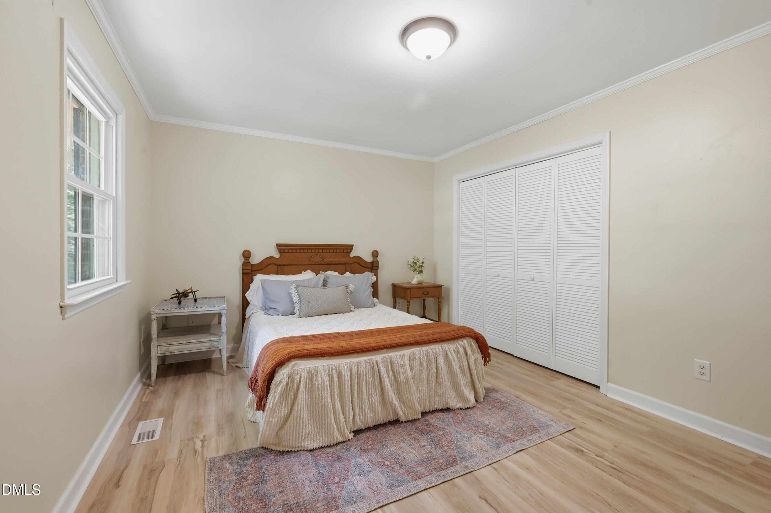 7811 Buckhorn Road Hillsborough, NC 27278 - Photo 22 of 47 a bedroom with a bed and wooden floor