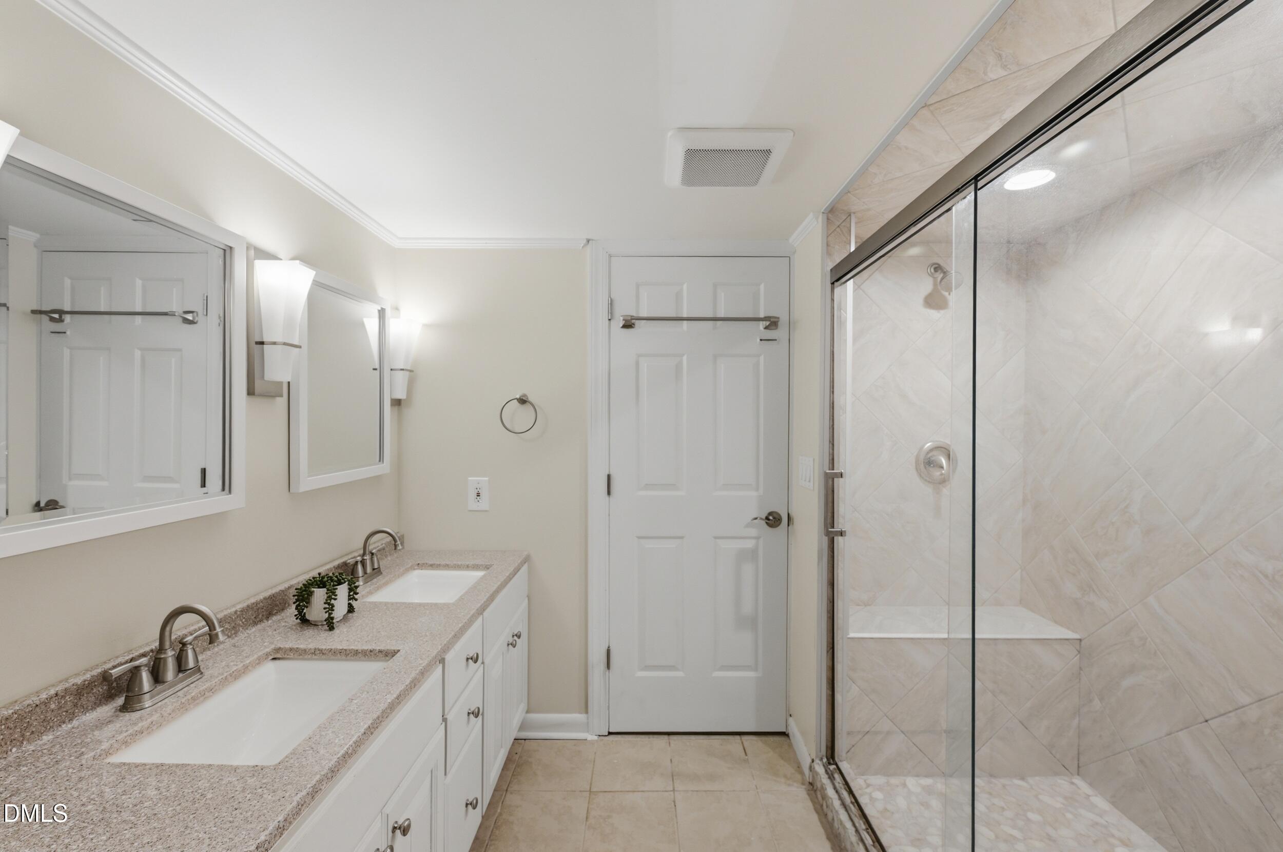 7811 Buckhorn Road Hillsborough, NC 27278 - Photo 31 of 47 a bathroom with double vanity sink and shower