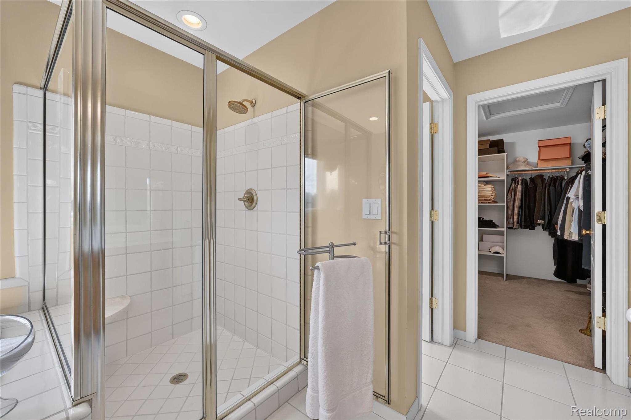 3804 Elk Drive Rochester, MI 48306 - Photo 42 of 75 Glass-enclosed shower featuring white square tile, a built-in bench, and a brushed nickel shower head
