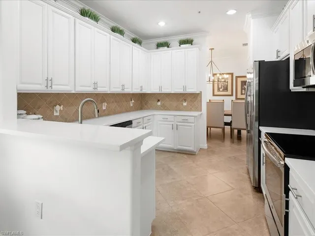 a kitchen with a sink a stove and cabinets