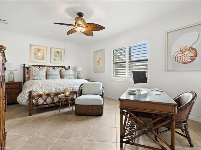 a bedroom with a bed and a desk