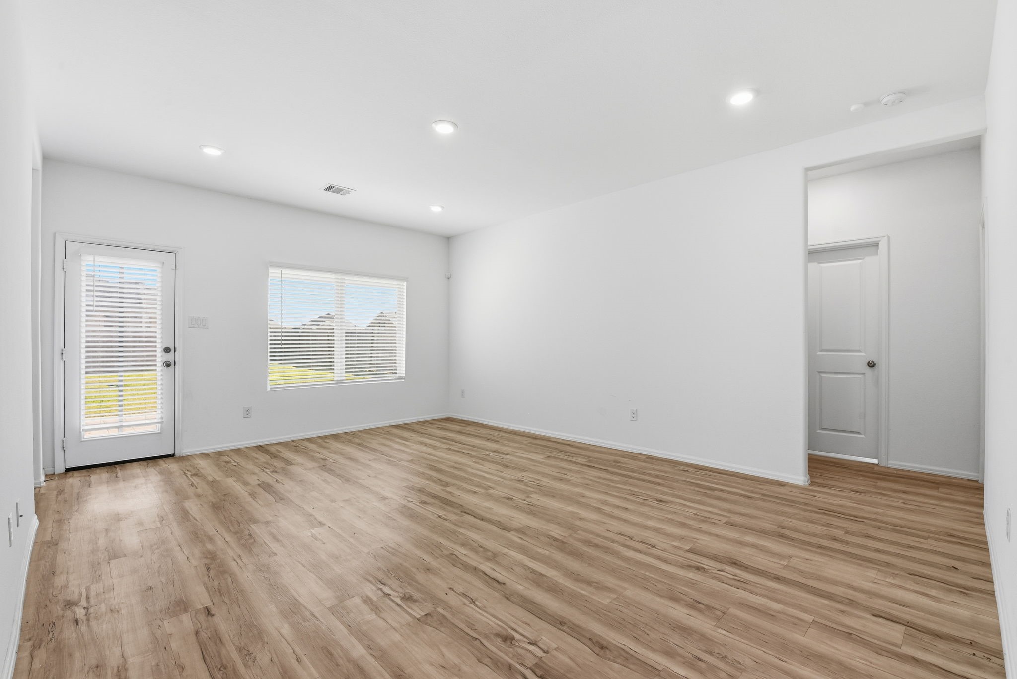 9010 Brazos Drive Baytown, TX 77521 - Photo 15 of 37 an empty room with wooden floor and windows