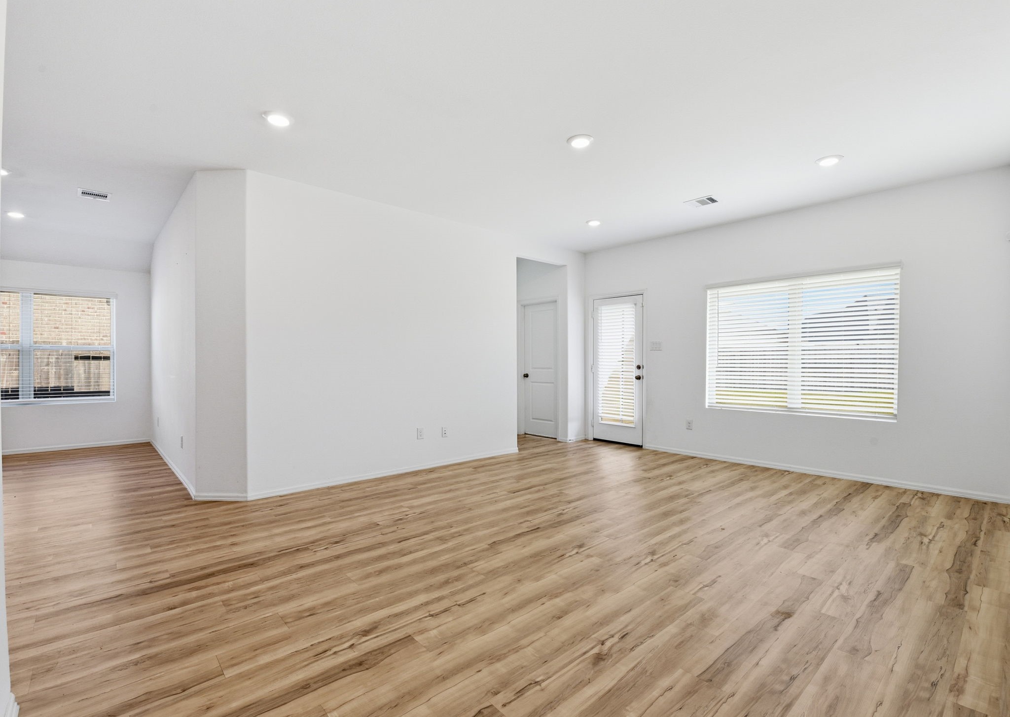 9010 Brazos Drive Baytown, TX 77521 - Photo 16 of 37 an empty room with wooden floor and windows