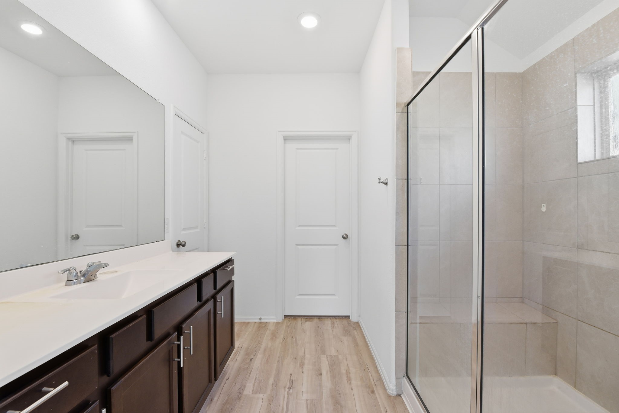 9010 Brazos Drive Baytown, TX 77521 - Photo 22 of 37 a bathroom with a sink a mirror and a shower