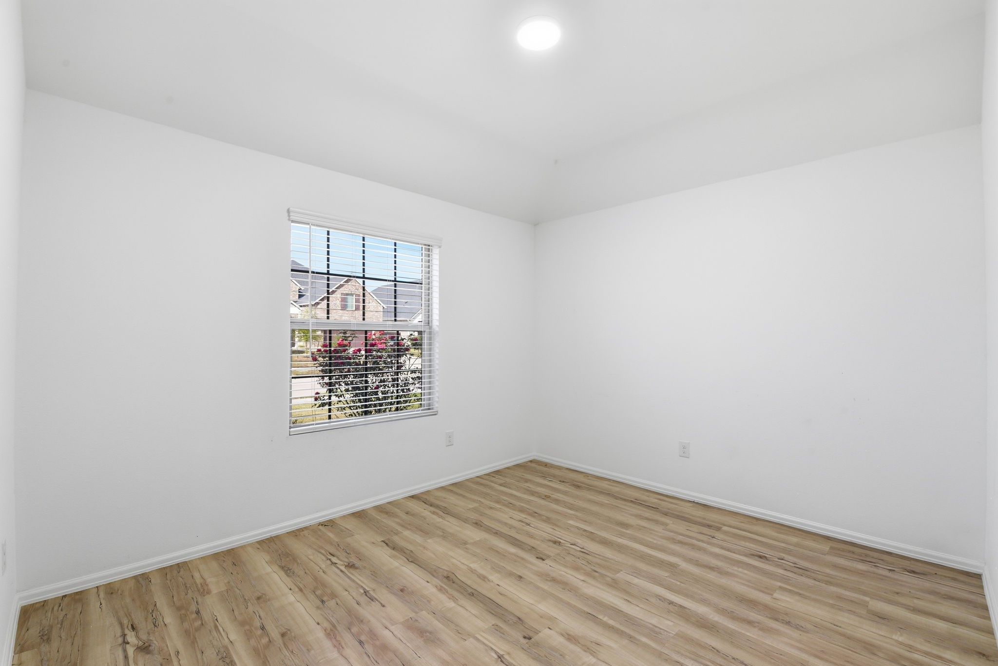 9010 Brazos Drive Baytown, TX 77521 - Photo 32 of 37 an empty room with wooden floor and windows