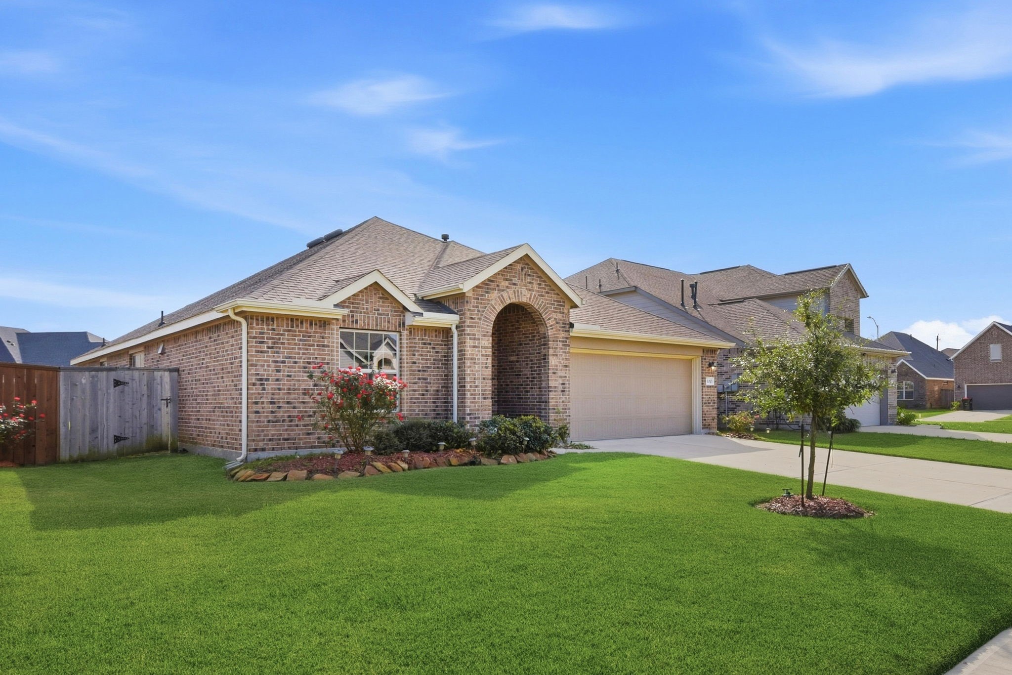 9010 Brazos Drive Baytown, TX 77521 - Photo 4 of 37 a front view of a house with a garden and yard