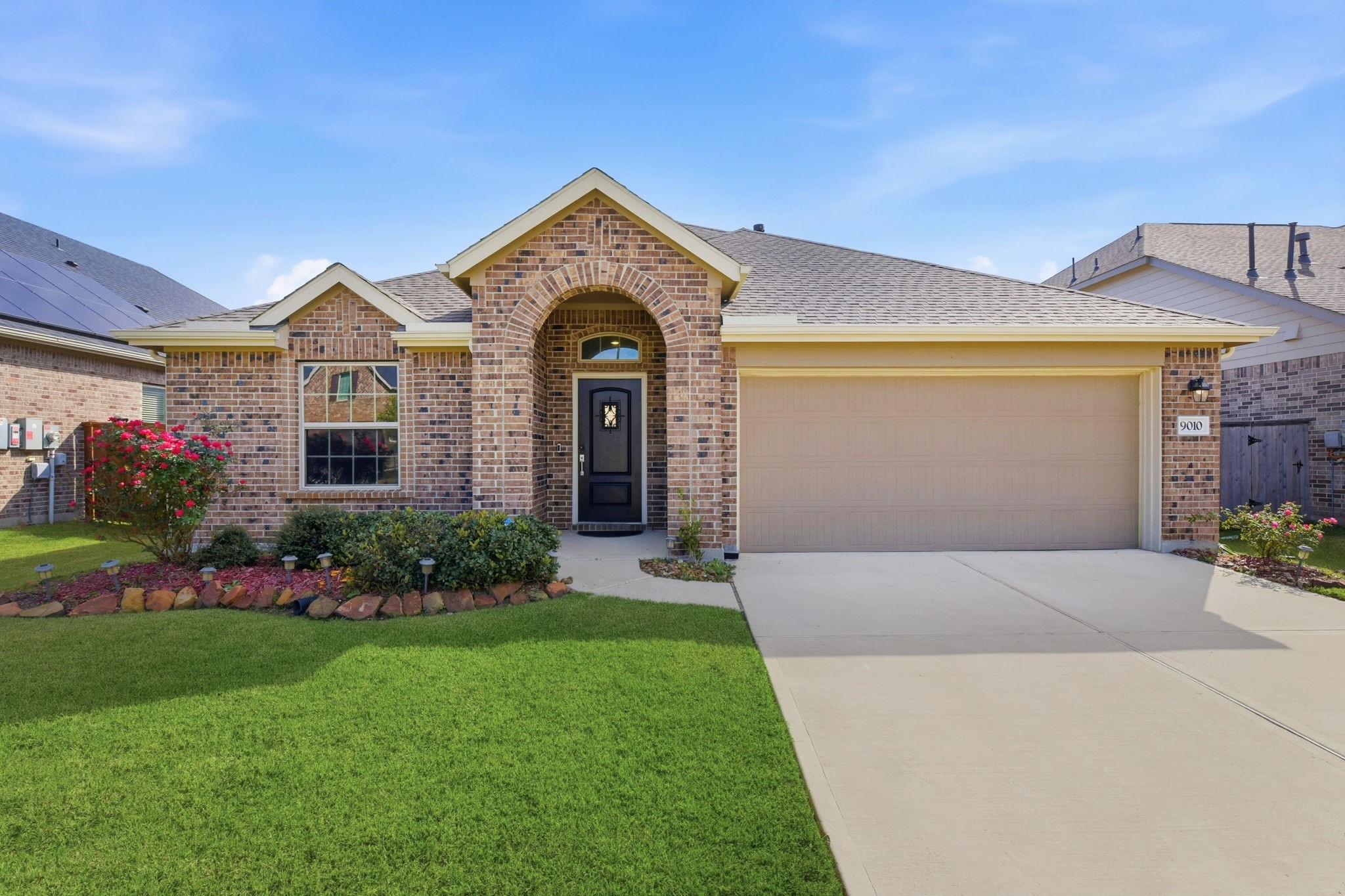 9010 Brazos Drive Baytown, TX 77521 - Photo 6 of 37 a front view of a house with a garden and plants
