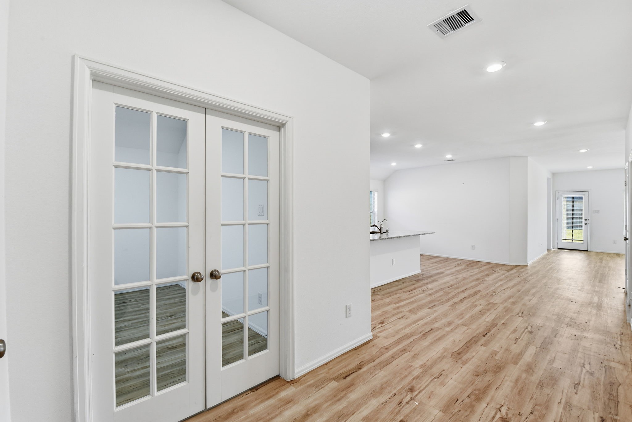 9010 Brazos Drive Baytown, TX 77521 - Photo 8 of 37 a view of empty room with wooden floor and windows