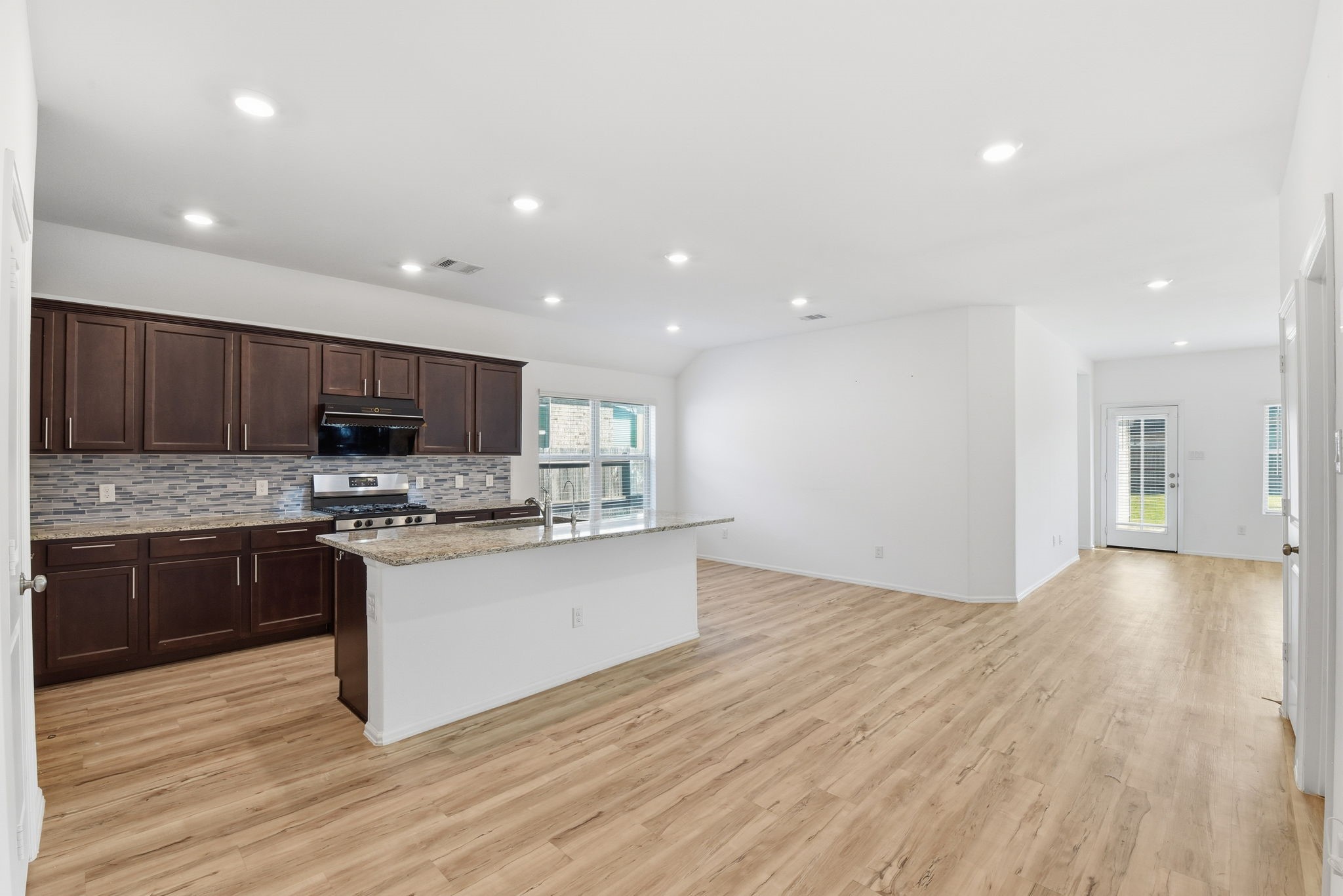 9010 Brazos Drive Baytown, TX 77521 - Photo 9 of 37 a kitchen with stainless steel appliances granite countertop a stove top oven a sink and a microwave