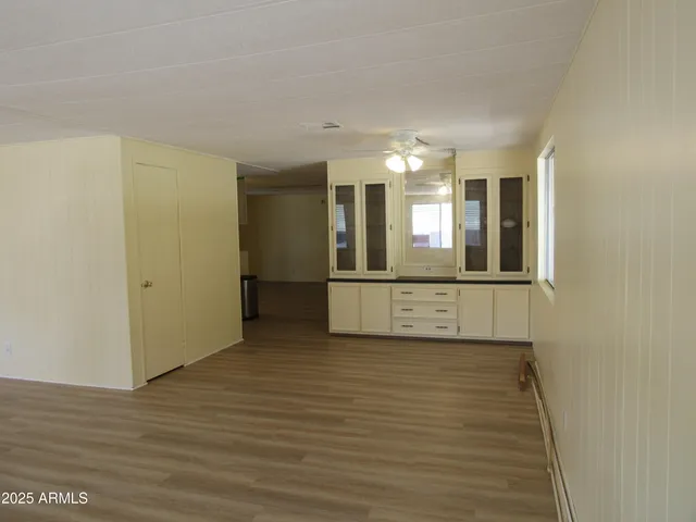 a view of a room with wooden floor and staircase