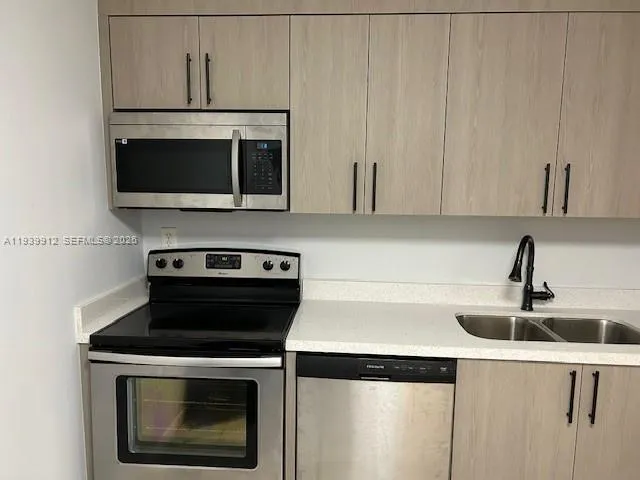 a kitchen with a stove and a microwave
