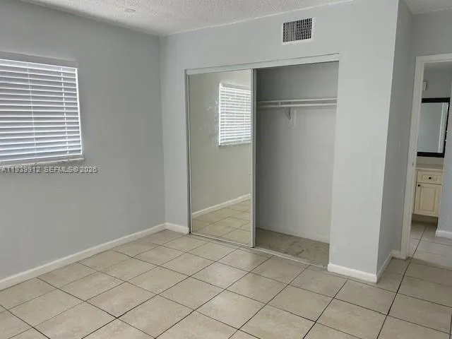 a view of an empty room and closet area