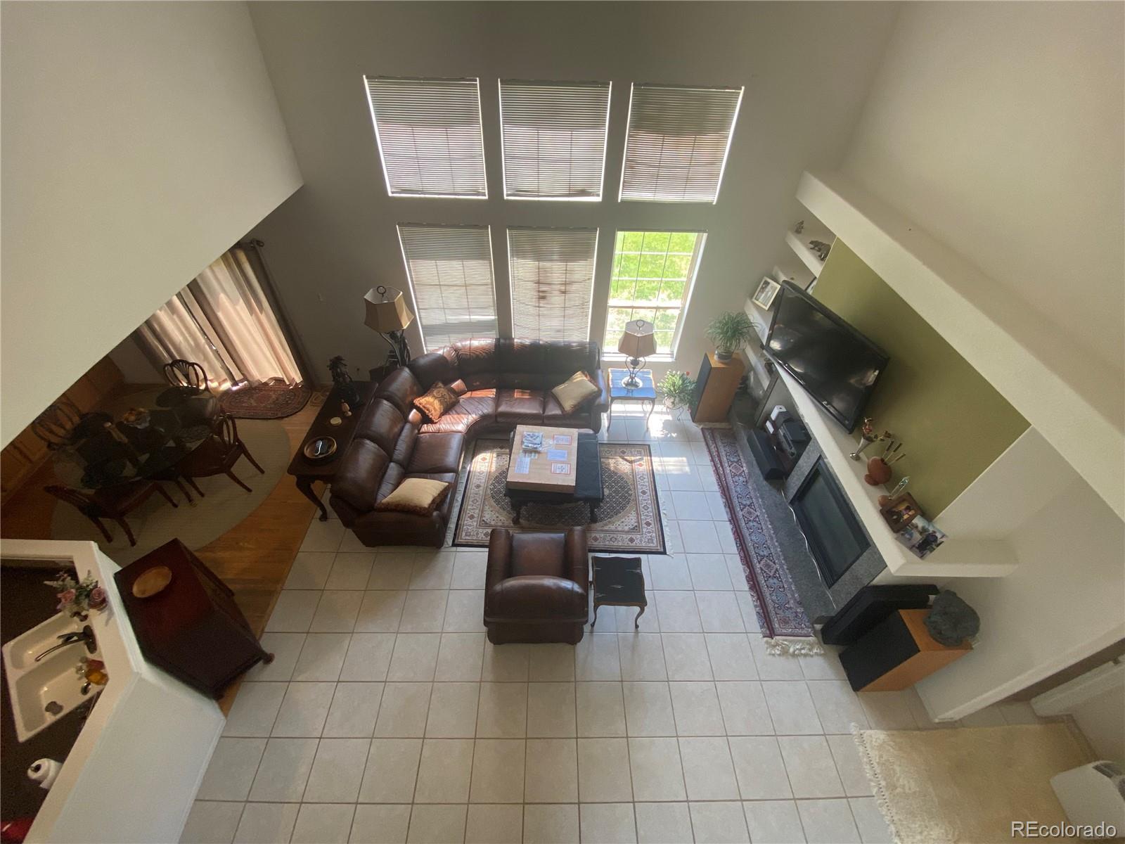 7100 Cerney Circle Castle Pines, CO 80108 - Photo 14 of 22 a living room with furniture and a flat screen tv