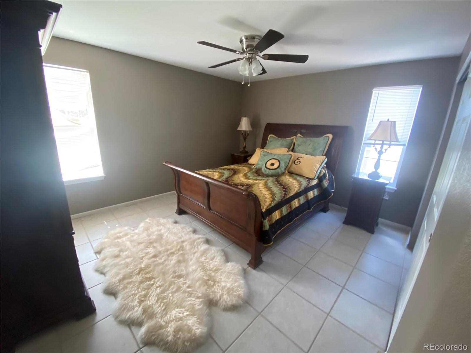 7100 Cerney Circle Castle Pines, CO 80108 - Photo 16 of 22 a spacious bedroom with a bed and window