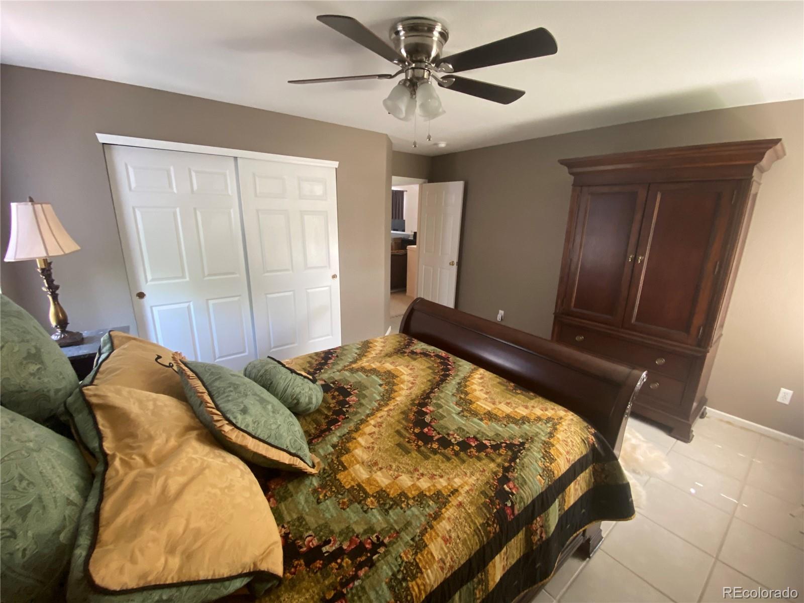 7100 Cerney Circle Castle Pines, CO 80108 - Photo 17 of 22 a bed sitting in a bedroom next to a window