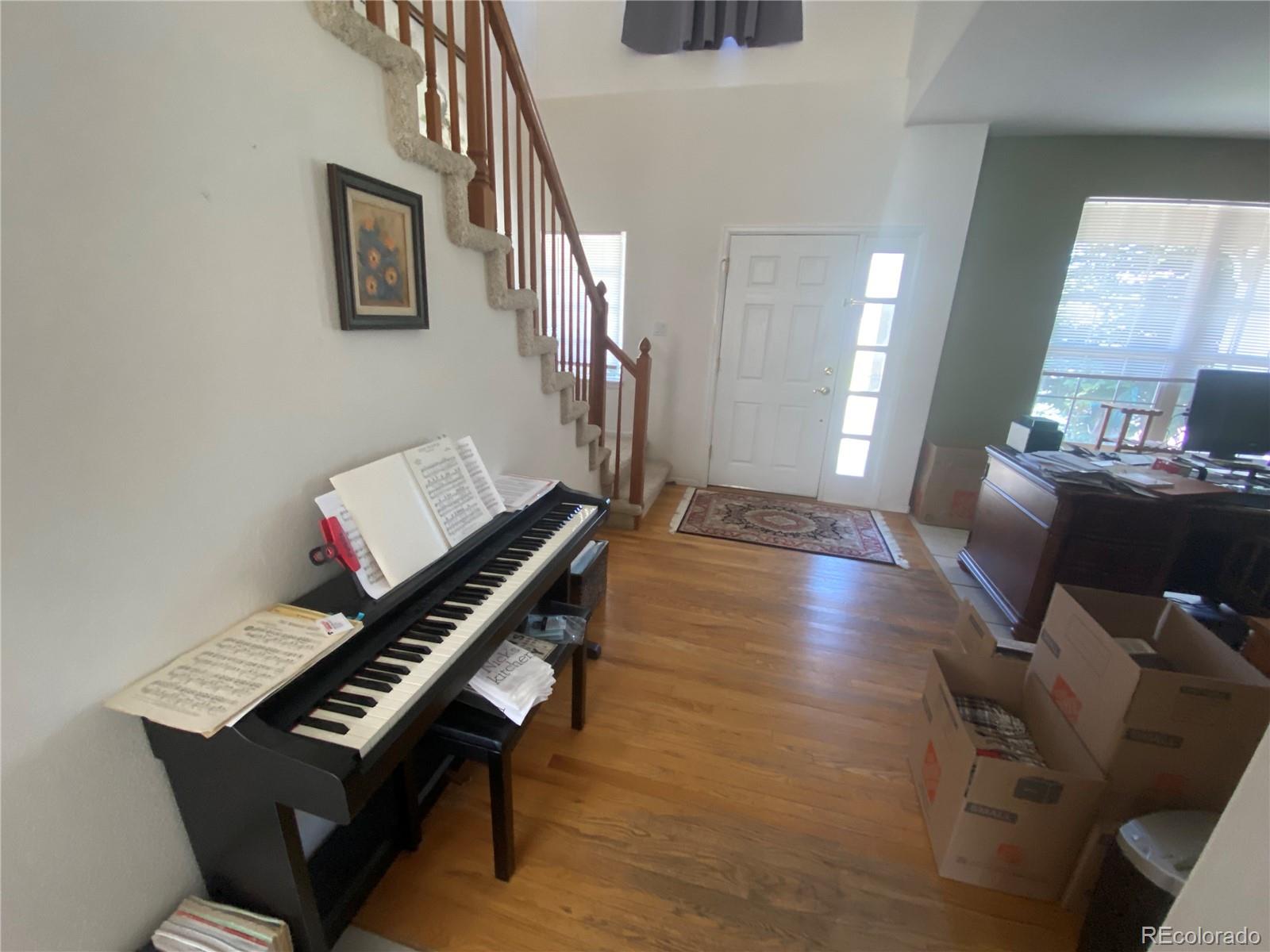 7100 Cerney Circle Castle Pines, CO 80108 - Photo 3 of 22 a living room with furniture and a piano