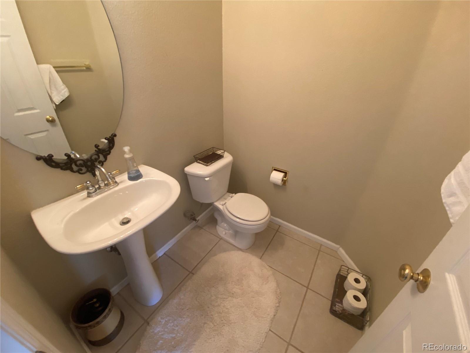 7100 Cerney Circle Castle Pines, CO 80108 - Photo 4 of 22 a bathroom with a sink toilet and mirror