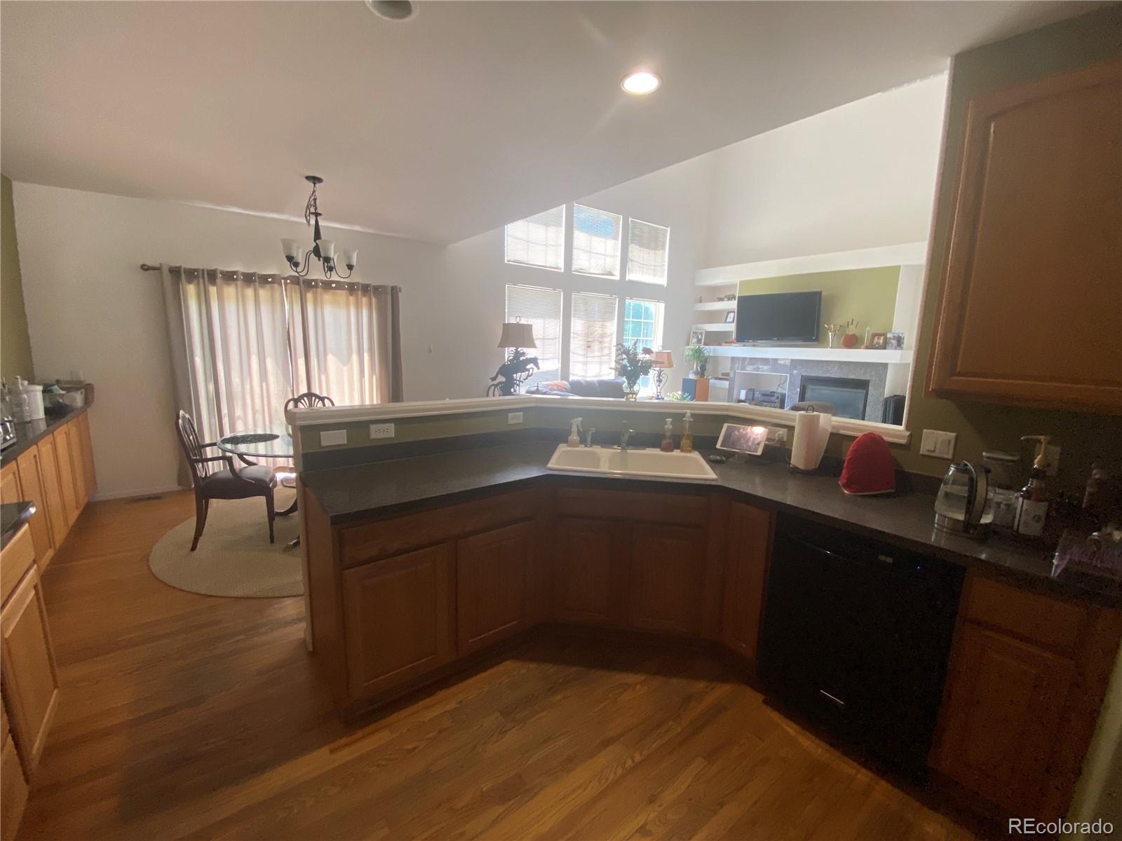 7100 Cerney Circle Castle Pines, CO 80108 - Photo 8 of 22 a kitchen with a sink appliances and cabinets