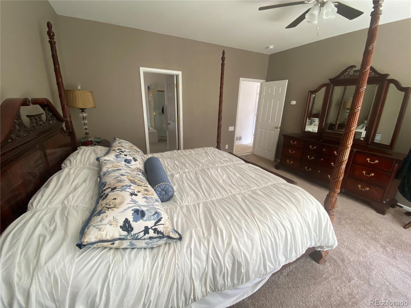 7100 Cerney Circle Castle Pines, CO 80108 - Photo 10 of 22 a bedroom with a bed and wooden floor