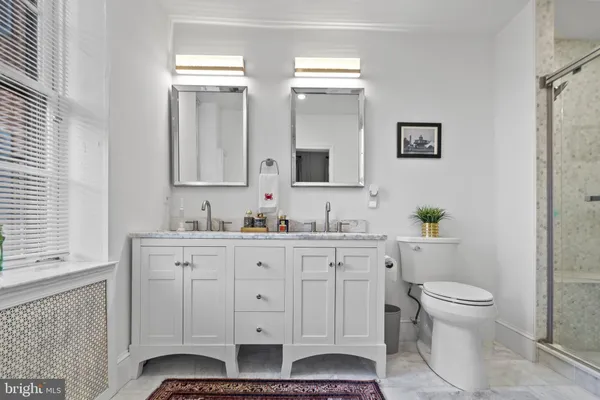 a white toilet sitting next to a bathroom sink